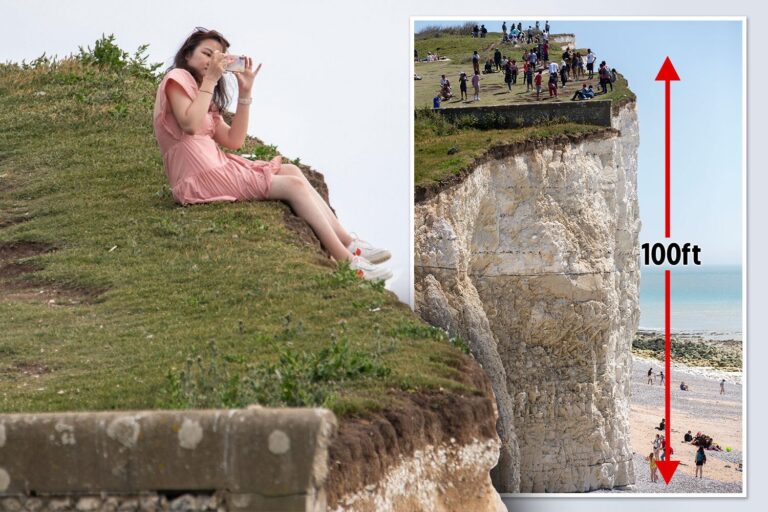 Tourist risks life to snap photo dangling legs over crumbling 100ft cliff edge