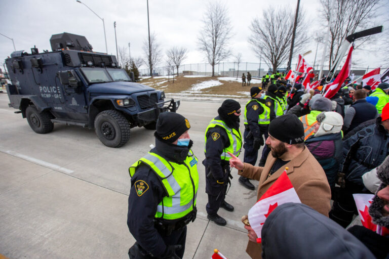 Truckers pull out vehicles from key US-Canadian border bridge, protests swell elsewhere